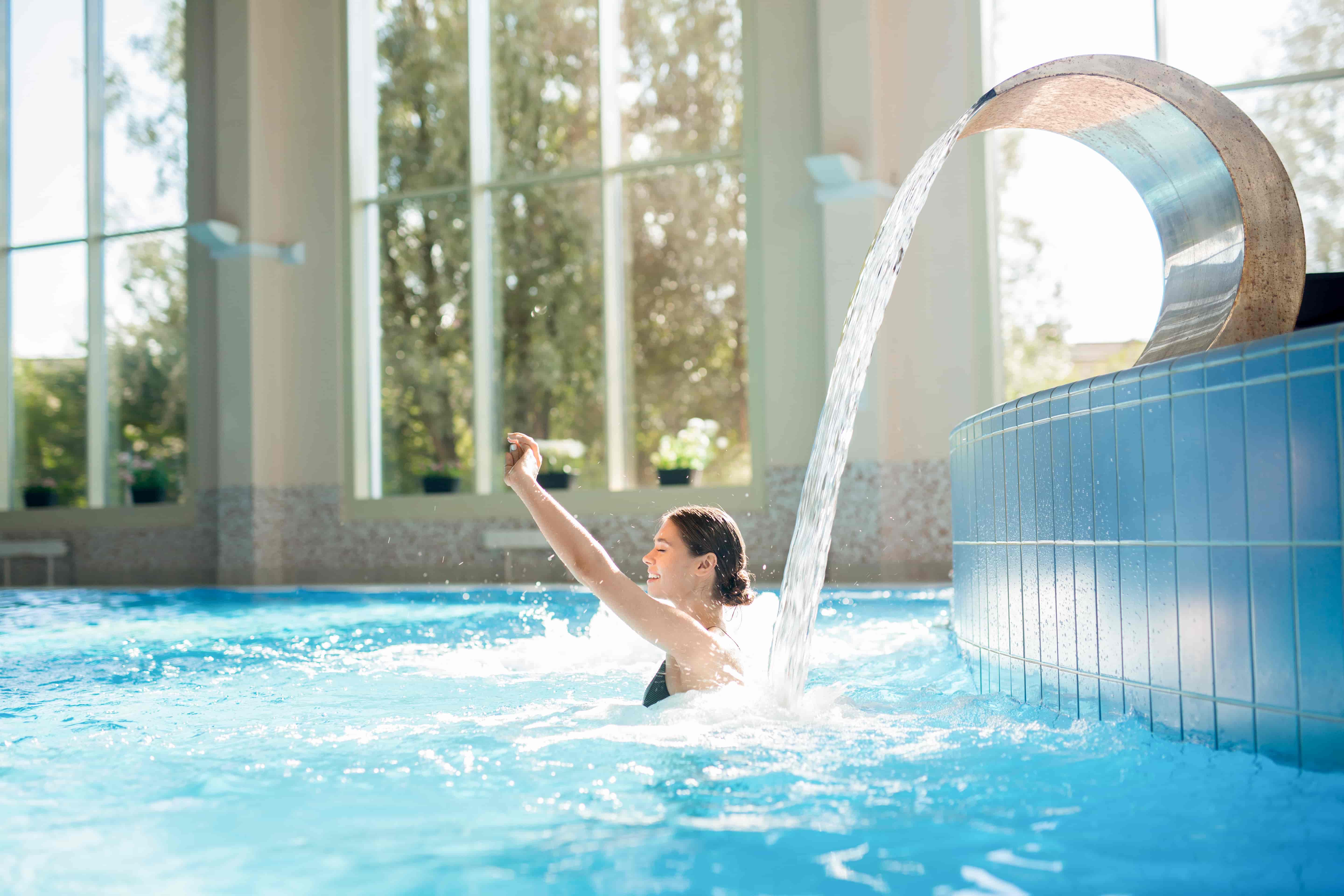 Women waterfall swimming pool